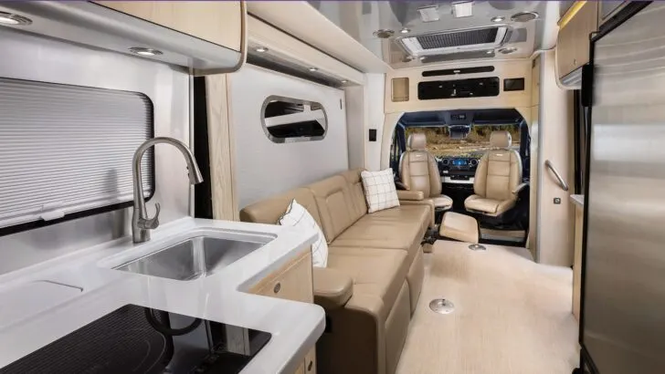 A full-size convertible bed (in couch mode) in an Airstream Atlas