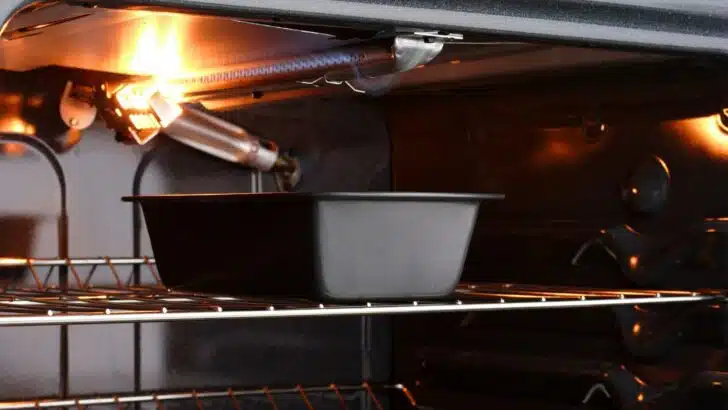 A small gas oven with a small bread pan inside