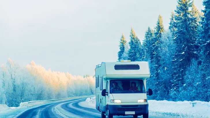 An RV traveling on the road in snowy winter conditions