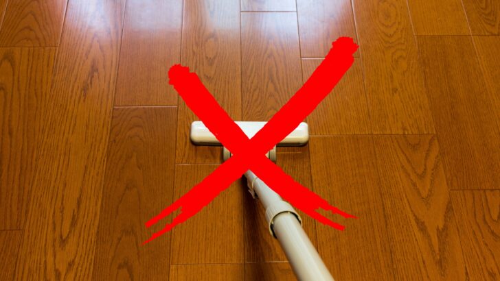 A vacuum on a hardwood floor with a red X 