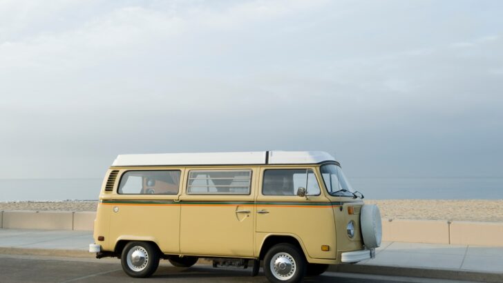 A VW camper van parked by the beach