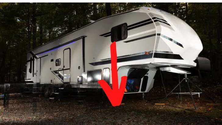A 5th wheel travel trailer with a red arrow indicating the significant distance from an upper bedroom to the ground