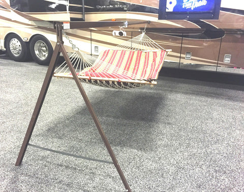 An Aire Nest DELUXE portable hammock and stand mounted on the side of one of Newmar's luxury motorcoaches