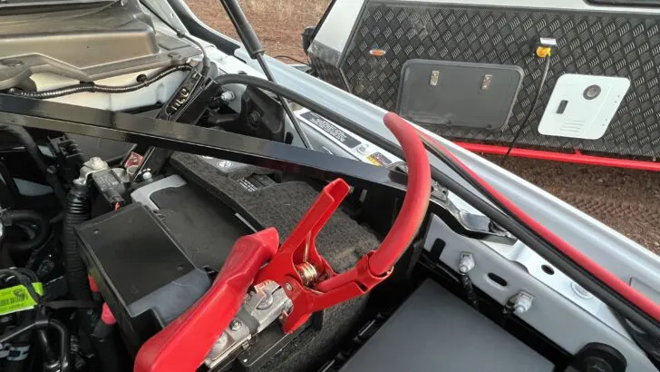 The alligator clips from a CarGenerator shown connected to our truck's battery