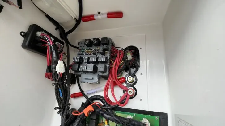 A small Proteng RV fire suppression tube installed in an electrical bay containing fuses