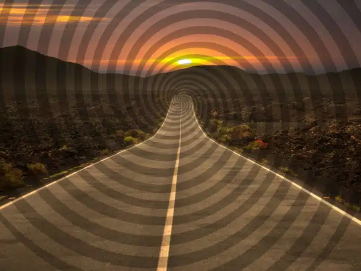 Hypnotic swirl over a scenic highway disapperaing into the distance