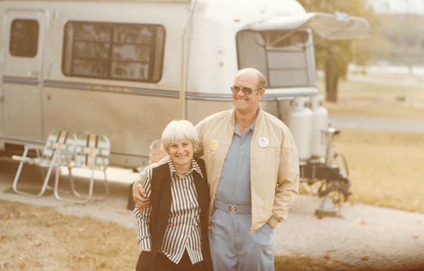 Kay and Joe Peterson, founders of the Escapees RV Club, standing in front of their RV.