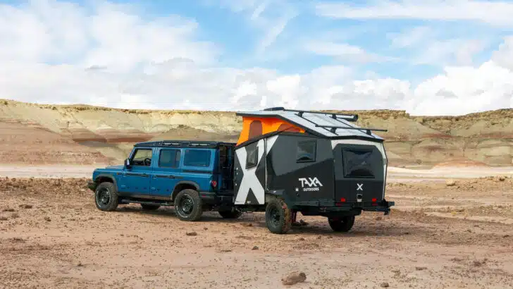 A TAXA Trailer being towed in rugged terrain