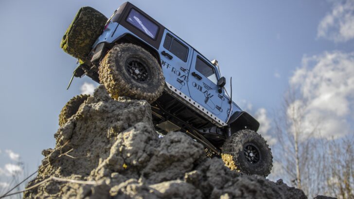 A Jeep Wrangler Rubicon shown poised on high rocks