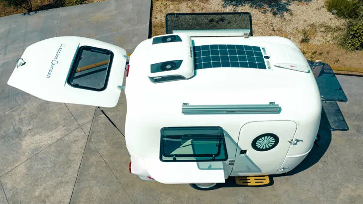 Solar and air packages shown on the roof of a Happier Camper travel trailer
