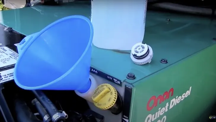 Fill the expansion tank with water during the Onan Quiet Diesel 7500 coolant change.
