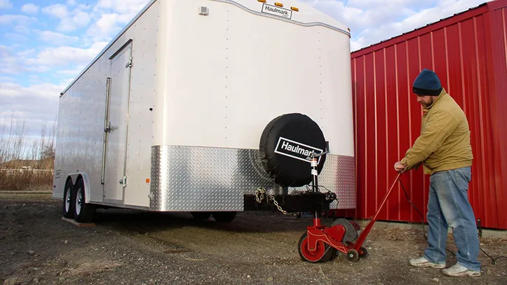 A Power Caster trailer mover moving a large enclosed trailer.