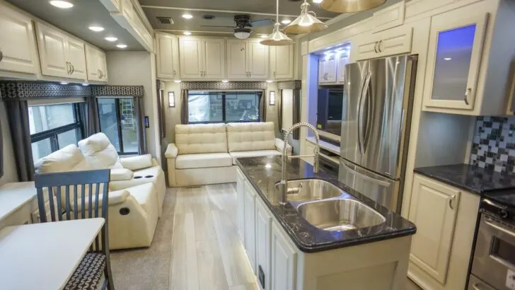 A kitchen/living area of a Luxe Elite fifth wheel. This is definitely a good example of a luxury fifth wheel camper.