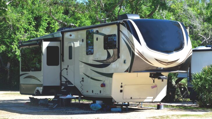 A luxury fifth wheel camper at a campsite.