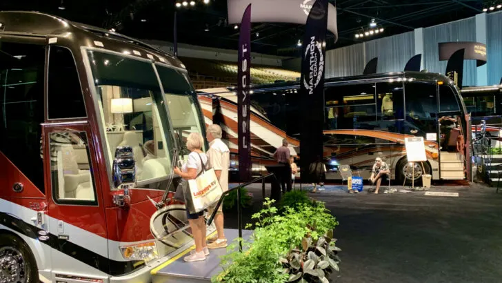 People looking into one of many beautiful Class A motorhomes at the Tampa RV Show