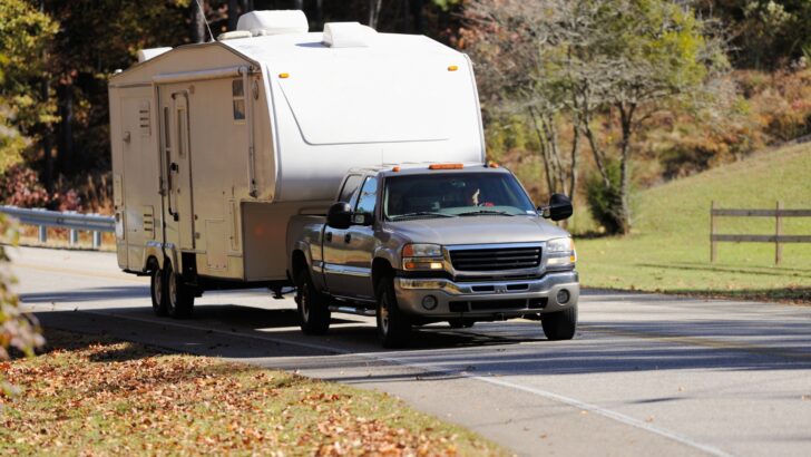 A pickup truck towing a fifth wheel camper