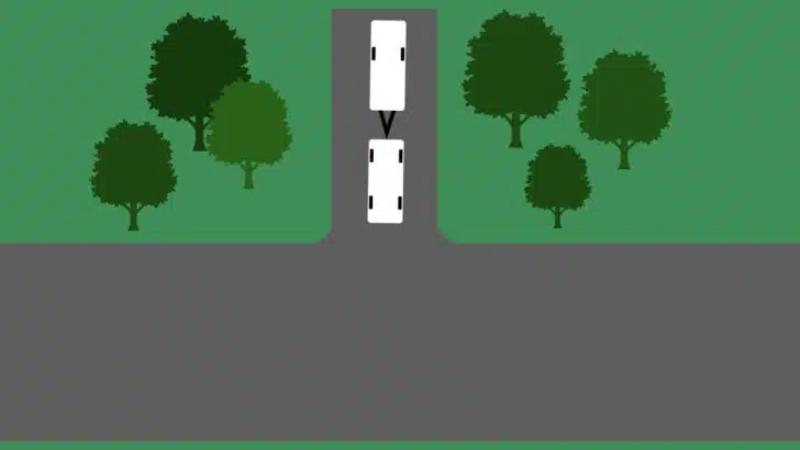 A travel-trailer camper backed into a campsite