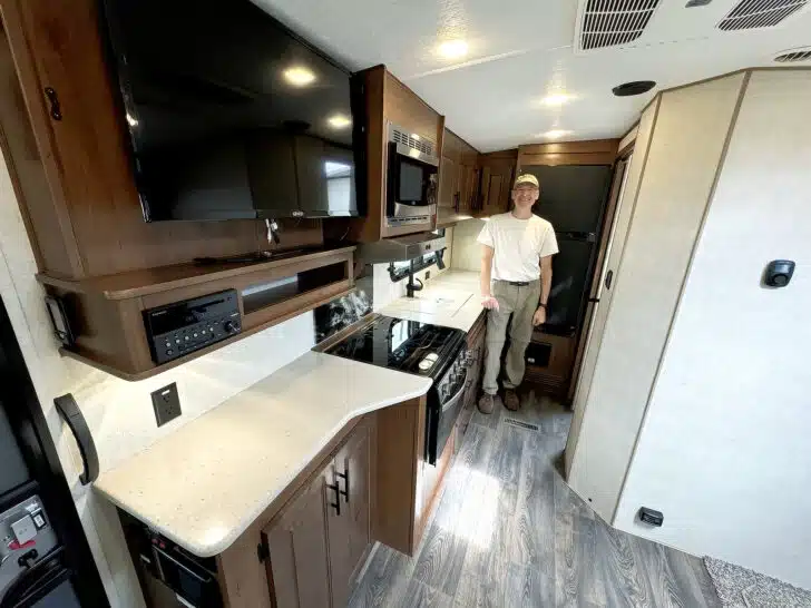 Peter standing in the kitchen of our new travel trailer