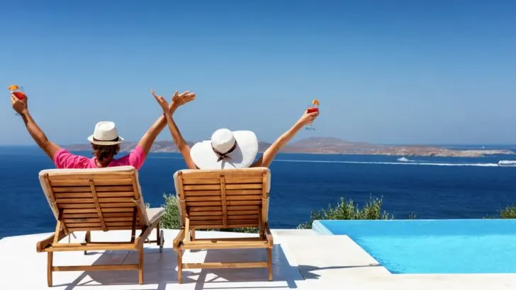 Two people celebrating warm weather in a beautiful location epitomizes the answer to the question "what is a snowbird?"