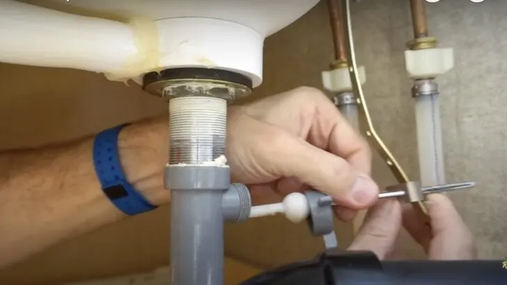Removing a drain stopper as part of RV faucet replacement.