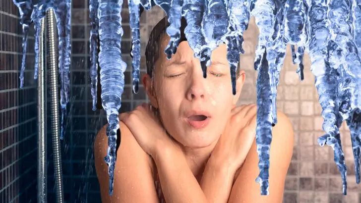 A woman bracing herself from a cold shower