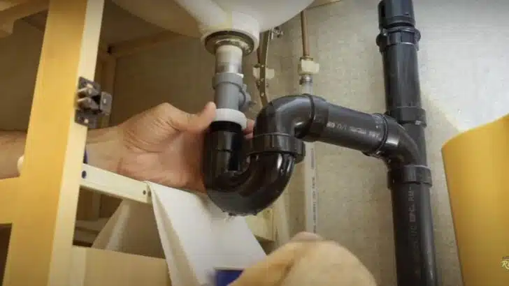 Removing the P-trap as part of our RV faucet replacement.