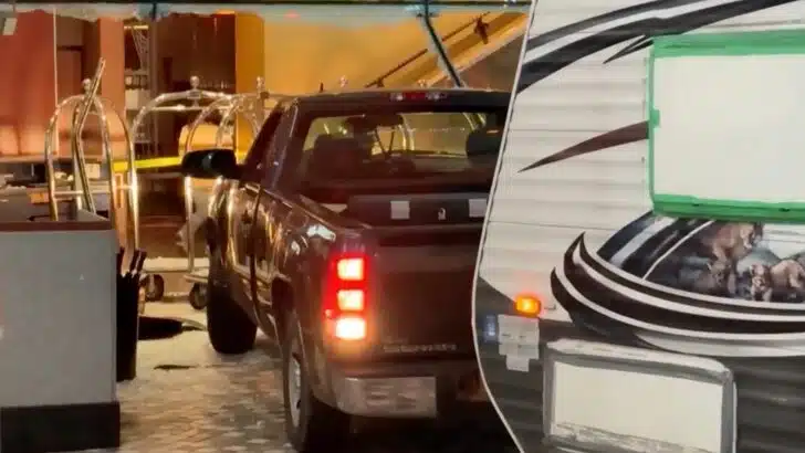 Pickup truck with travel trailer backing out of hotel