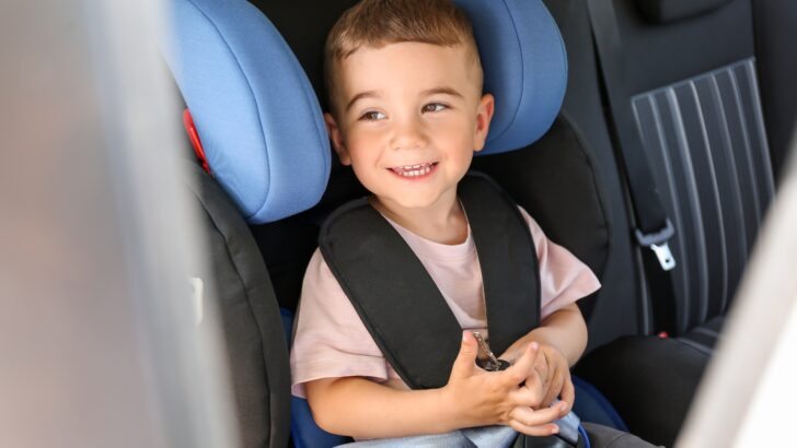 A child in a legal car safety restraint system
