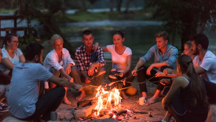 A group of friends cooking over a campfire
