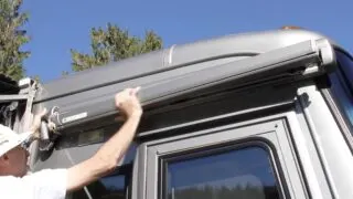 Removing the motor while holding the awning securely