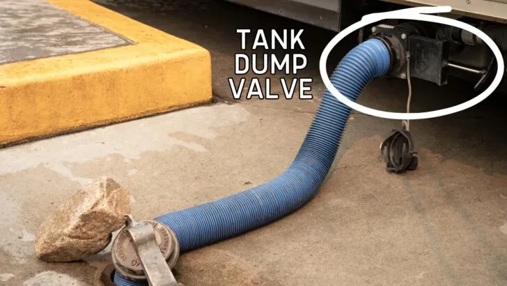An RV hooked up to dump, showing where the tank dump valve is located