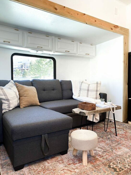 A cozy aftermarket corner couch in an RV slide