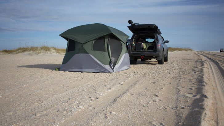 An SUV being used as an overlanding vehicle with a tent