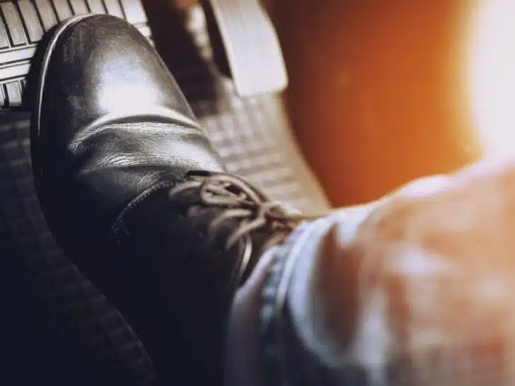 A foot on a vehicle's brake pedal