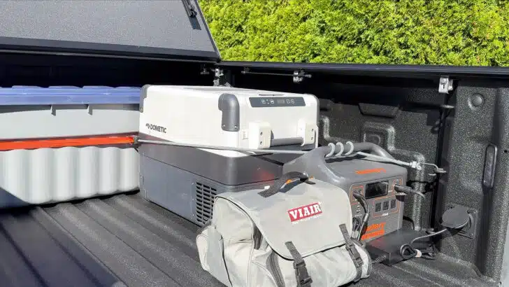The gear we typically carry in the bed of our truck - Jackery, Dometic fridge, and Viair compressor